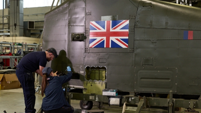 Aircraft maintenance technician apprentices at working on a Royal Air Force Chinook at Middle Wallop