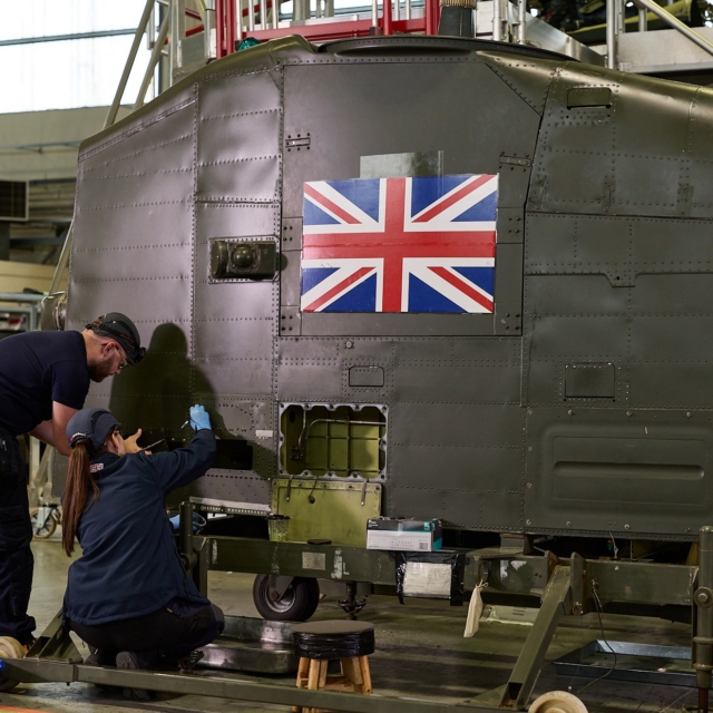 Aircraft maintenance technician apprentices at working on a Royal Air Force Chinook at Middle Wallop