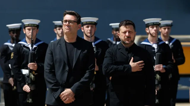 President Zelenskyy salutes as his national anthem is played
