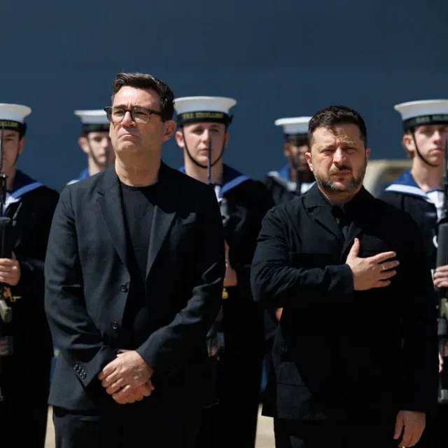 President Zelenskyy salutes as his national anthem is played