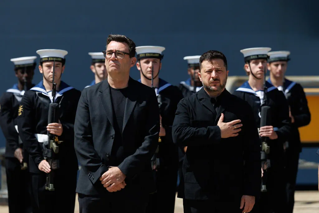 President Zelenskyy salutes as his national anthem is played