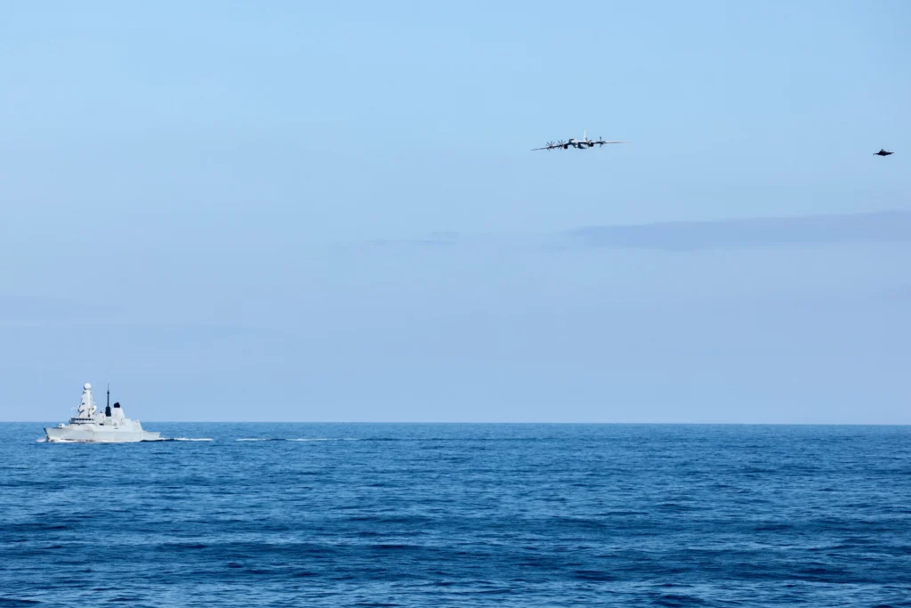 Russian Tu-142 maritime patrol aircraft and British F-35B fly over Royal Navy destroyer