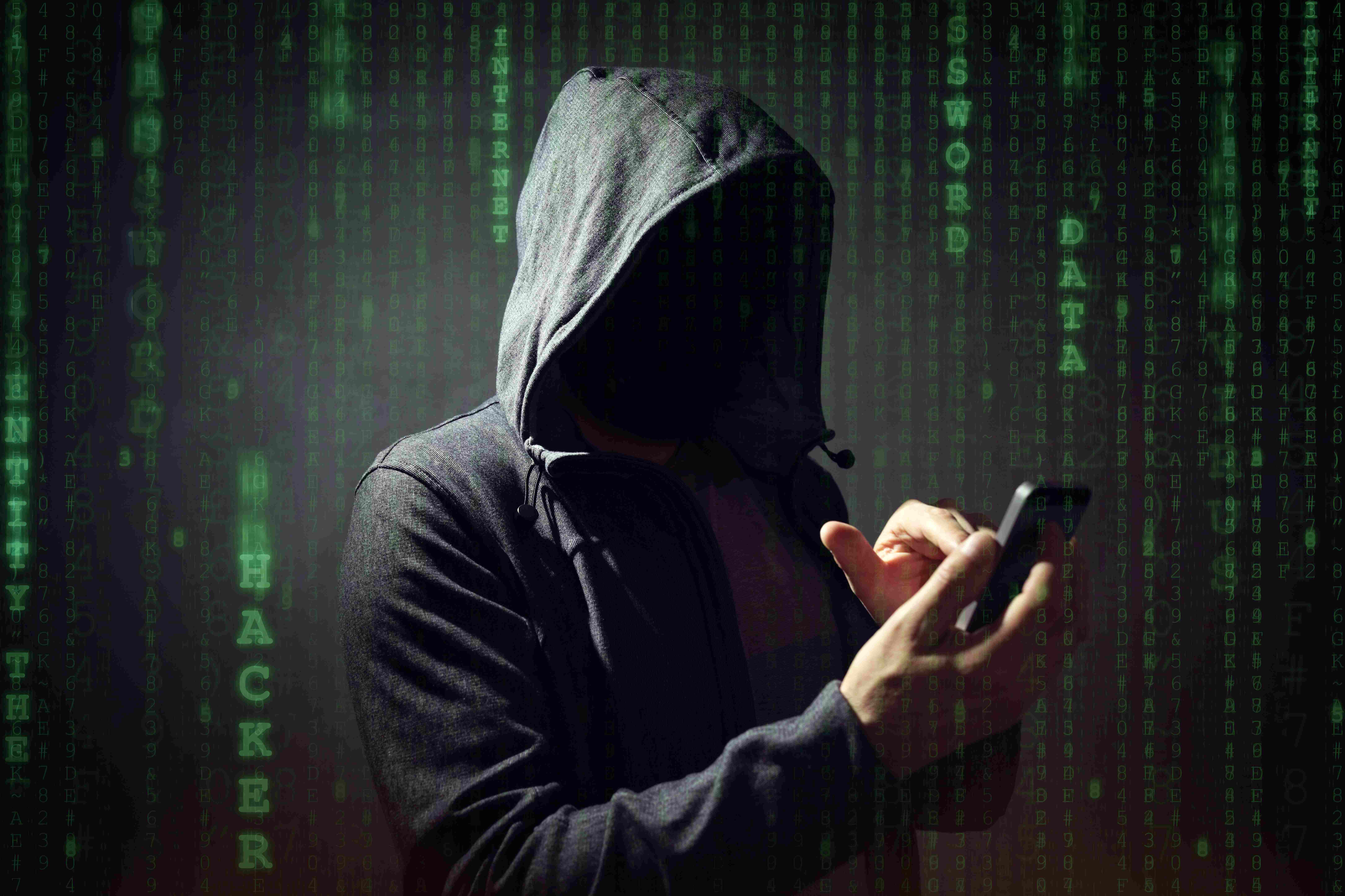 Computer hacker with mobile phone smartphone stealing data