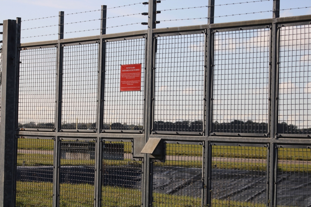 Shot of a fence with a red sign in Doncaster Sheffield Airport