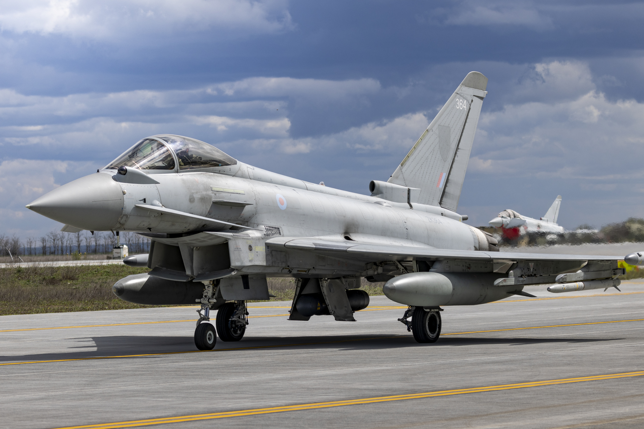 A Typhoon FGR4 (serial ZK364) from the RAF's No 3(F) Squadron taxis to the runway at the 86th Air Base in Borcea, Romania, before launching for a 'Tango' QRA training scramble on 7 April 2026. Image: MOD Crown Copyright/AS1 Ben Webb