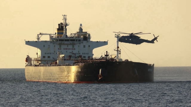 A Royal Navy-operated Merlin HM4 hovers over the deck of the sanctioned Cameroonian-flagged crude oil tanker and suspected Russian 'shadow fleet' vessel, Smyrtos, during a maritime interdiction mission to seize the vessel on 14 June 2026. Image: MOD Crown Copyright/Royal Navy
