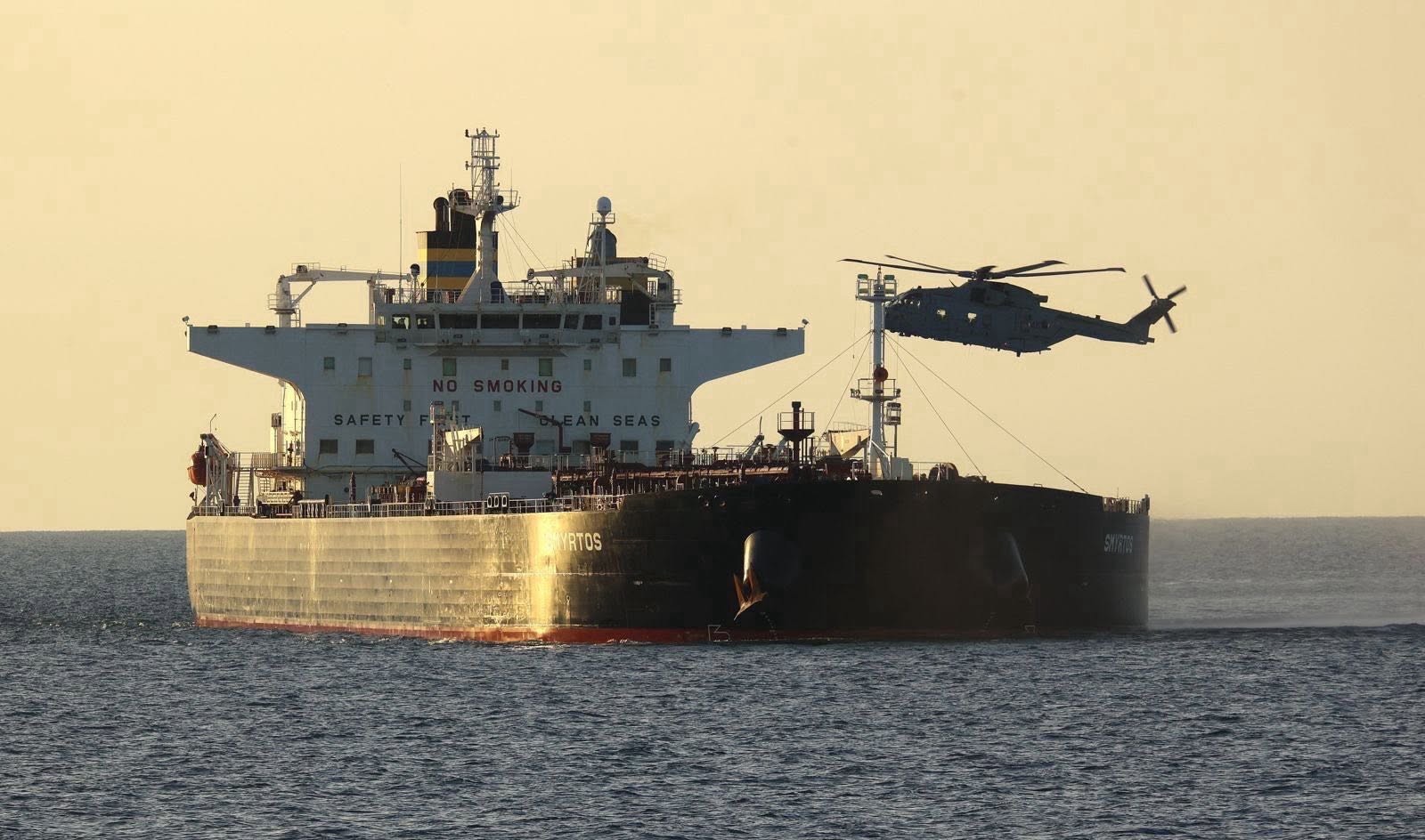 A Royal Navy-operated Merlin HM4 hovers over the deck of the sanctioned Cameroonian-flagged crude oil tanker and suspected Russian 'shadow fleet' vessel, Smyrtos, during a maritime interdiction mission to seize the vessel on 14 June 2026. Image: MOD Crown Copyright/Royal Navy