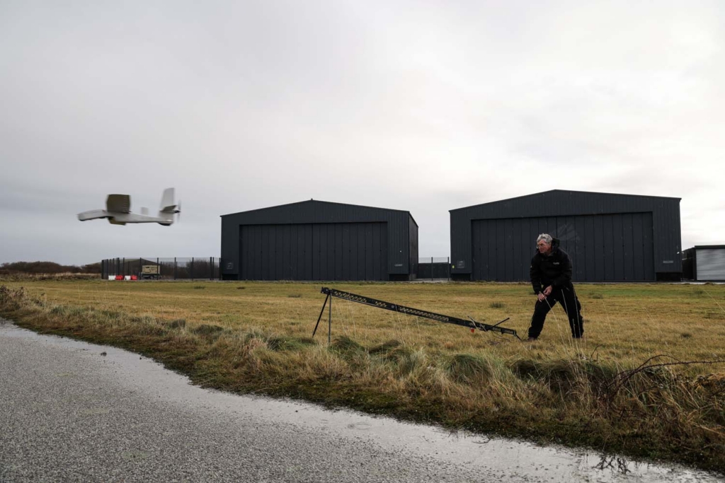 Royal Navy Wildcat helicopter transmitting live data from multiple drones during flight.
