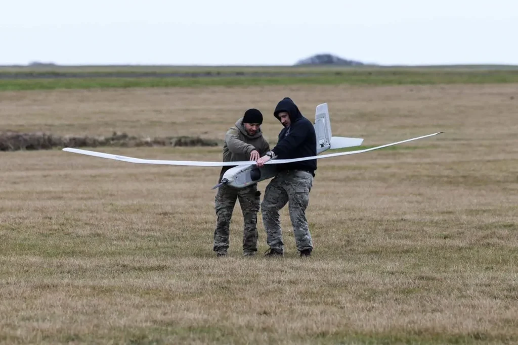 Royal Navy helicopters have used live data from multiple drones to target a moving vehicle
