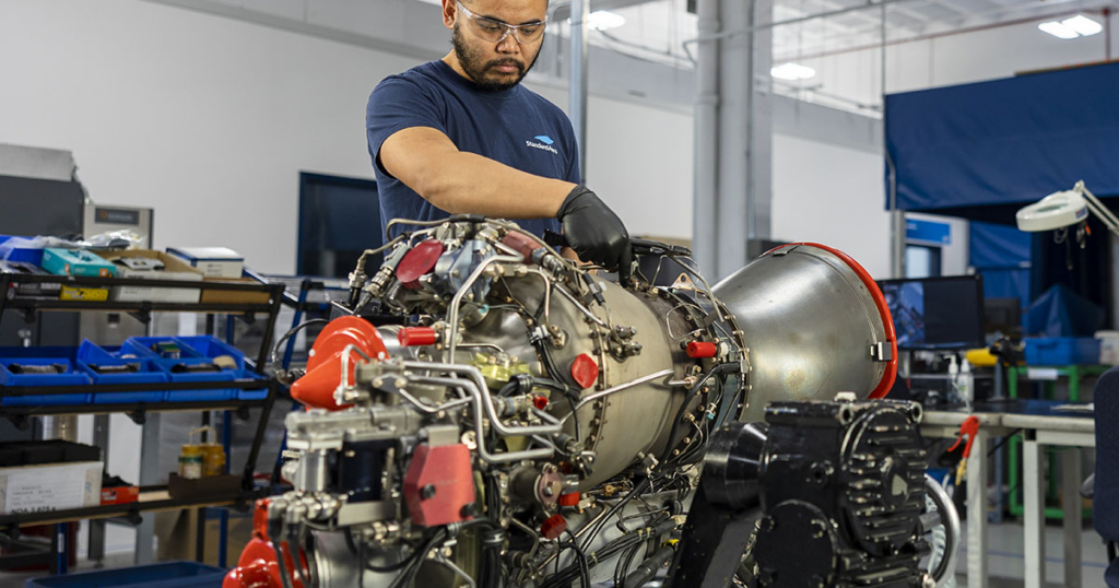 StandardAero engineer working on an engine
