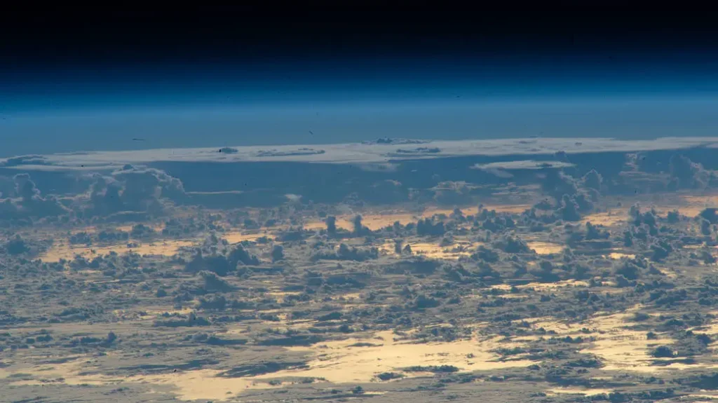 Clouds protrude above the north Atlantic Ocean in this oblique photograph from the International Space Station.