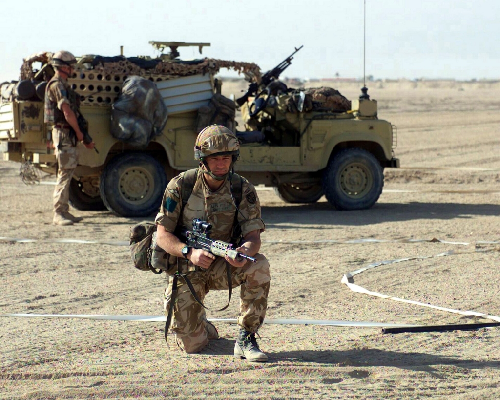 Exiting a Land Rover Defender Wolf, members of the 3rd Battalion, Parachute Regiment, British Army, demonstrate a vehicle checkpoint security for the Marines of 2nd Battalion, 6th Marines, at landing strip Viper, in support of Operation IRAQI FREEDOM.