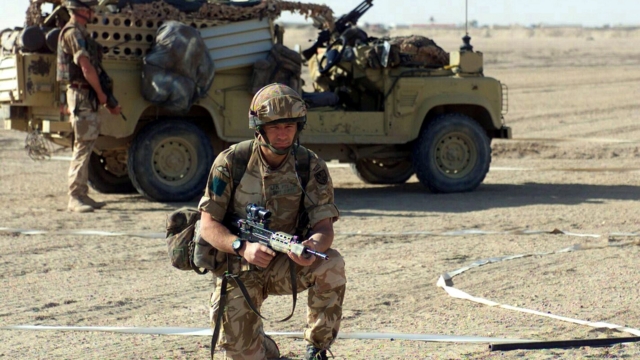 Exiting a Land Rover Defender Wolf, members of the 3rd Battalion, Parachute Regiment, British Army, demonstrate a vehicle checkpoint security for the Marines of 2nd Battalion, 6th Marines, at landing strip Viper, in support of Operation IRAQI FREEDOM.