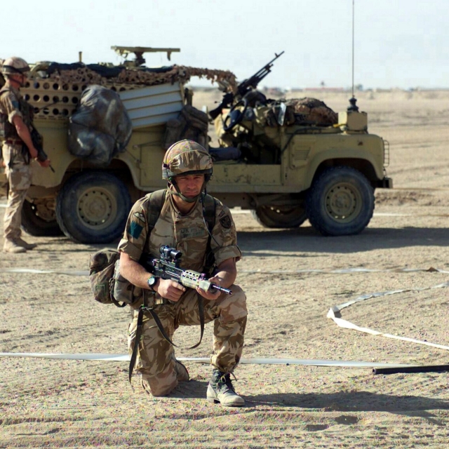 Exiting a Land Rover Defender Wolf, members of the 3rd Battalion, Parachute Regiment, British Army, demonstrate a vehicle checkpoint security for the Marines of 2nd Battalion, 6th Marines, at landing strip Viper, in support of Operation IRAQI FREEDOM.