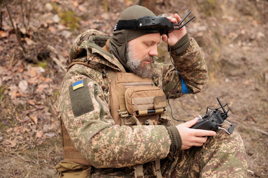 Ukrainian military man controls a drone