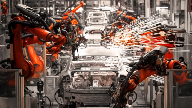 A robotic arm of the car production plant is working as UK automotive suppliers ask for help to secure defence contracts.