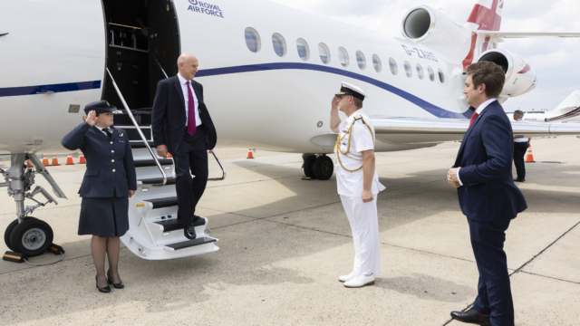 John Healey stepping off a private jet