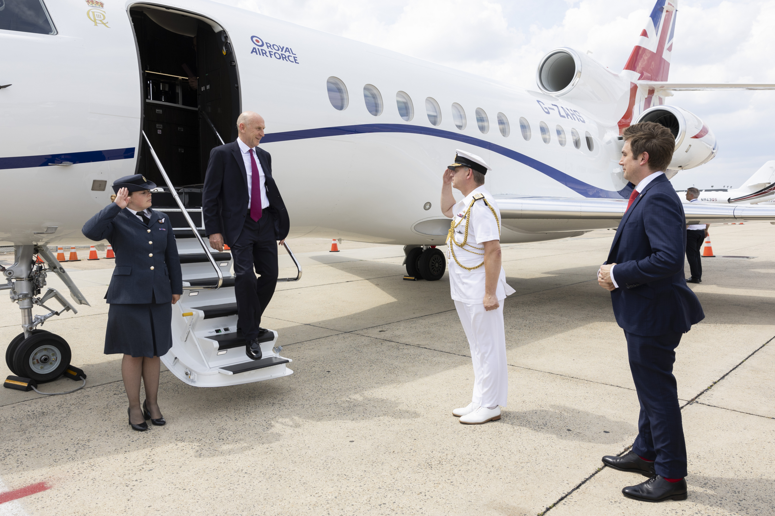 John Healey stepping off a private jet