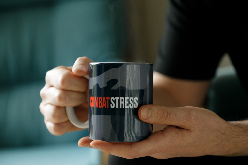 close up of someone holding a Combat Stress mug