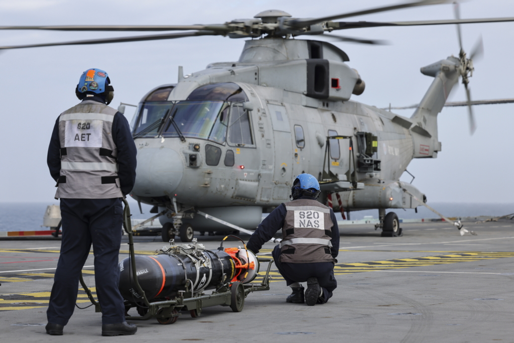 Sailors assigned to 820 NAS prepare to load a Training Variant Torpedo (TVT) onto a Merlin HM2 during a shipborne ASW training mission on 28 February 2024. Image: MOD Crown Copyright/LPhot Belinda Alker