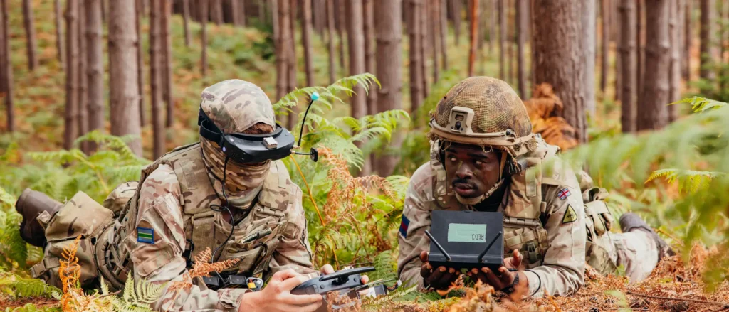 Tpr Harvey Chilman (left) and Tpr Darel Anderson (right) fly a FPV drone during the 'Drone Wars' competition. Image: MOD Crown Copyright/British Army