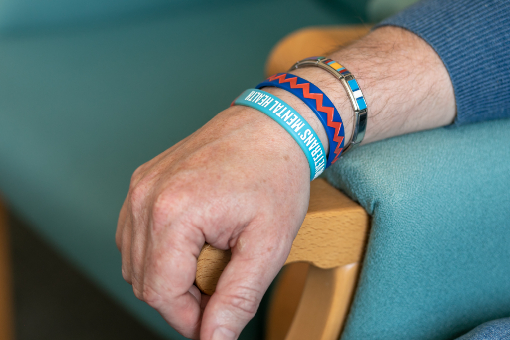 close up of someone's arm, wearing a Combat Stress bracelet